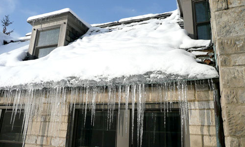 Ice dam on a home in winter