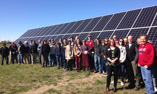 Tour participants gathered for a big group photo in front of Detroit Lake’s Community Solar Garden