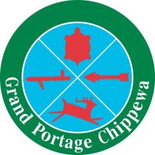 Grand Portage Chippewa logo. Blue circle containing red images of a deer, arrow, turtle and stick. Surrounded by a green circle with white text reading "Grand Portage Chippewa"