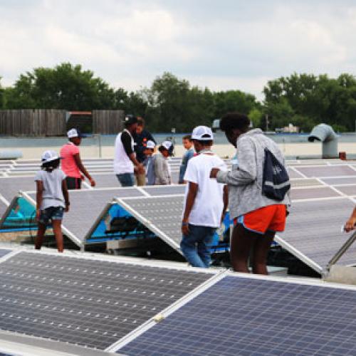 Students tour solar panels with Just-B-Solar Camp, part of Just Community Solar Coalition's effort to educate youth