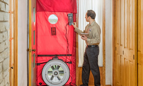 Blower door test to find leaks during energy audit. Photo courtesy Home Energy Squad