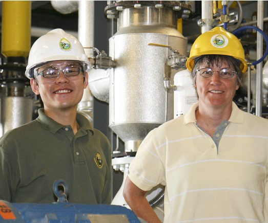 People in hard hats smiling at the camera