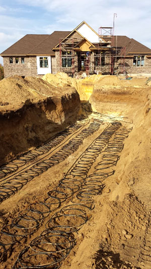 Ground-source heating and cooling coils looped horizontally under the Poppen's yard