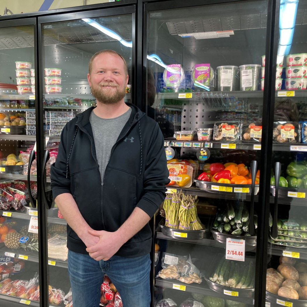 Owner of Aaron’s Grocery in Fertile with new, energy efficient coolers.