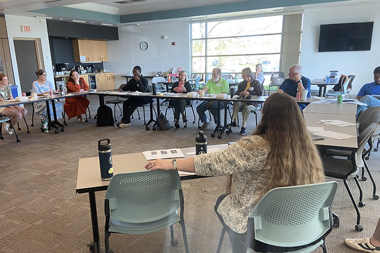 CEA members discussing as a group at a table