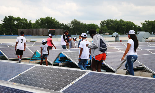 Students tour solar panels with Just-B-Solar Camp, part of Just Community Solar Coalition's effort to educate youth