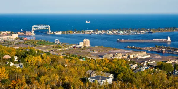 photo of Lake Superior and Duluth's harbor and trees; image from website of 2023 Midwest Climate Resilience Conference