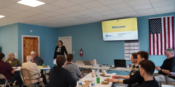 people in room listening to presentation; photo by Clean Energy Resource Teams