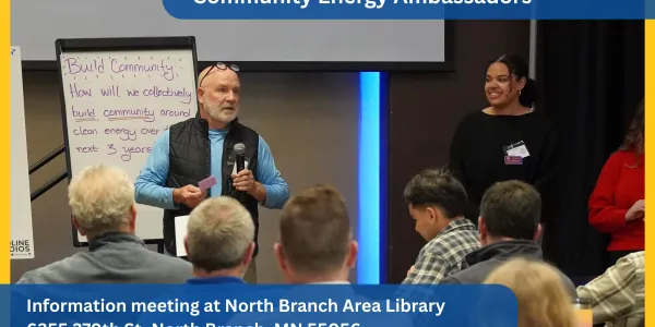 two people talking at a meeting; photo by Clean Energy Resource Teams
