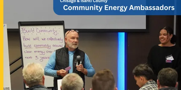 person standing in front of row of people; photo credit: Clean Energy Resource Teams