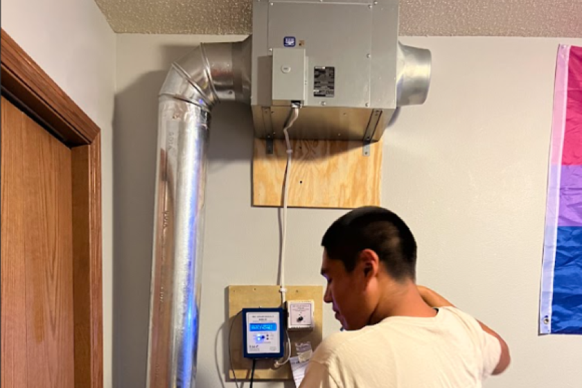 person inside a home with the fan that pull heat from the solar thermal panel inside