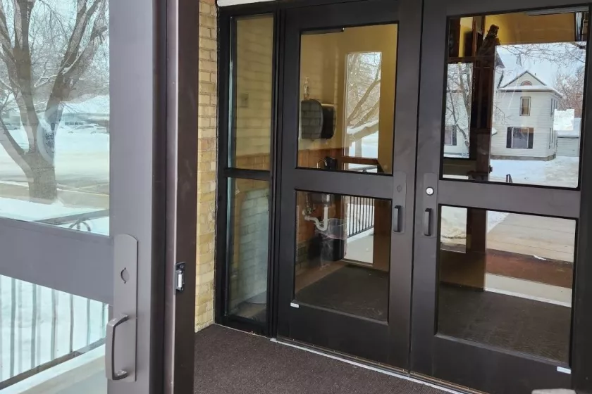 A vestibule with new interior and exterior doors.