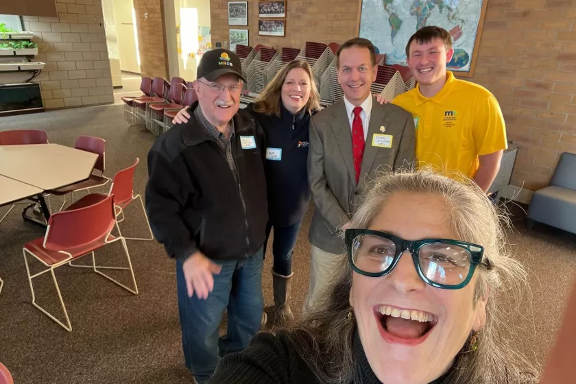 Certs staff pose for a selfie photo with community members