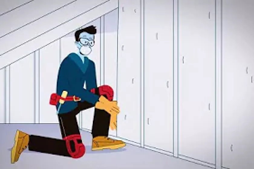 person inspecting insulation in an attic