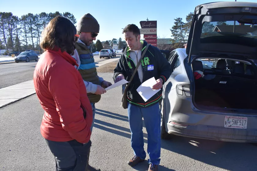 People speaking with an EV owners