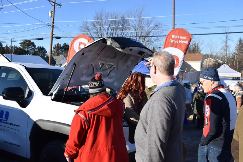 People looking at an EV