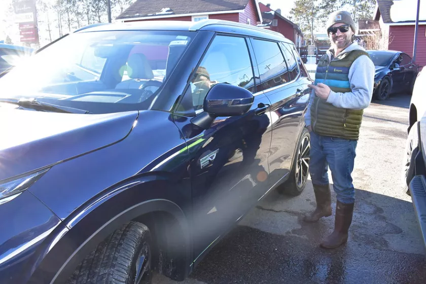 Person standing by an EV
