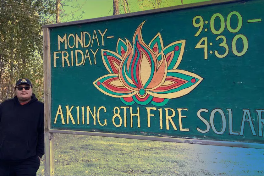 Gwe Gasco next to Akiing 8th Fire Solar sign
