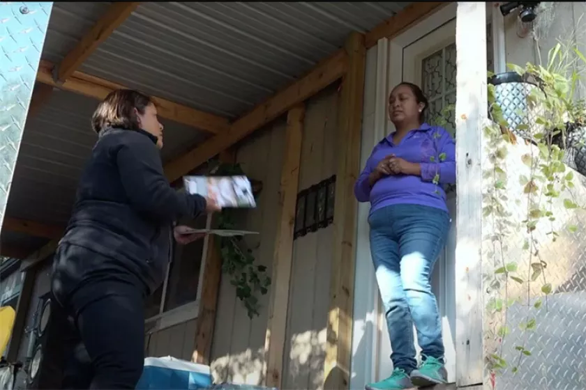 people talking at doorstep