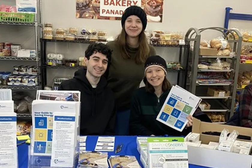  Rau (middle) and CERTs colleagues table at a local food shelf, disbursing information and resources about clean energy,