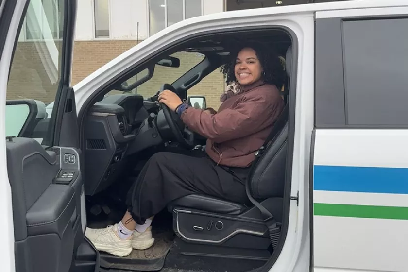Imani driving a truck