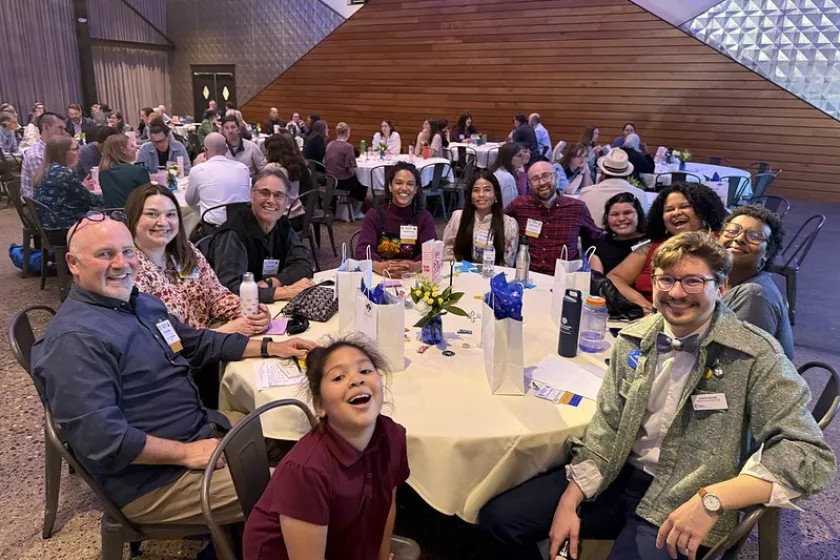 Aaron Backs sits at a table with community members during the CERTs Annual Metro Event.