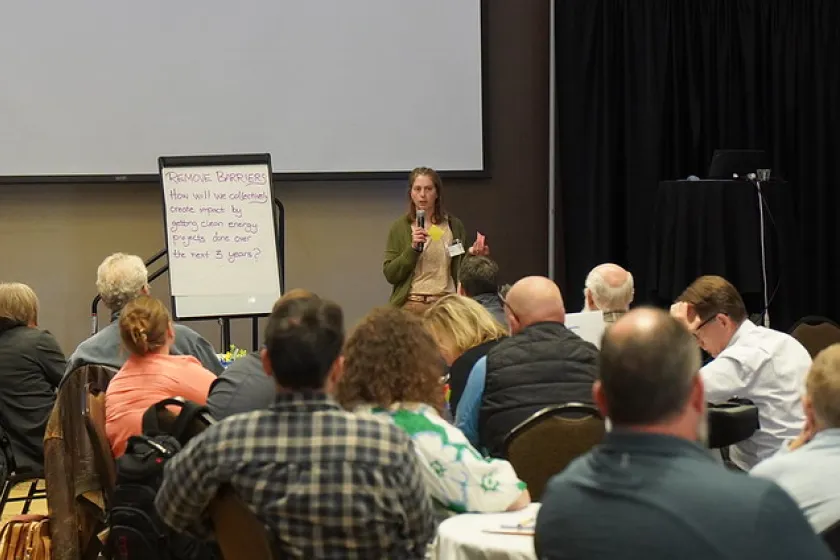 People gathered at tables in a large room