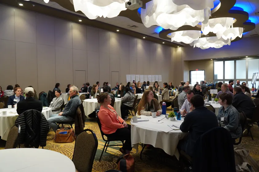 People gathered at tables in a large room