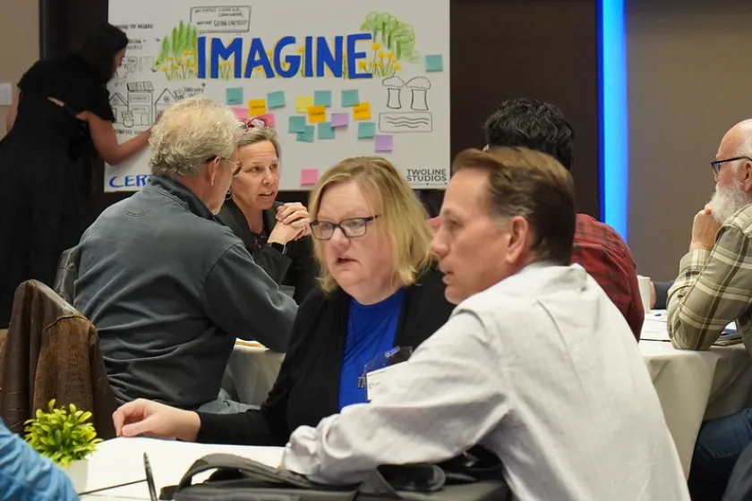 People gathered at tables in a large room
