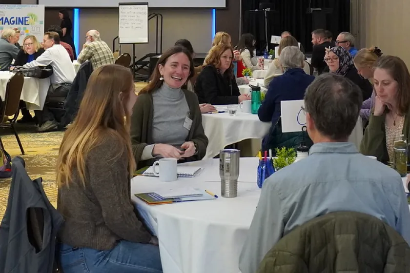 People gathered at tables in a large room