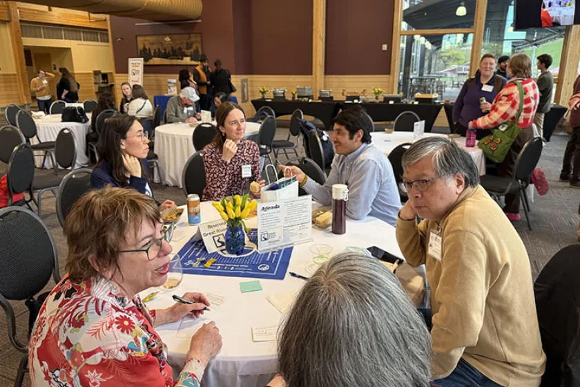 attendees conversing at a table