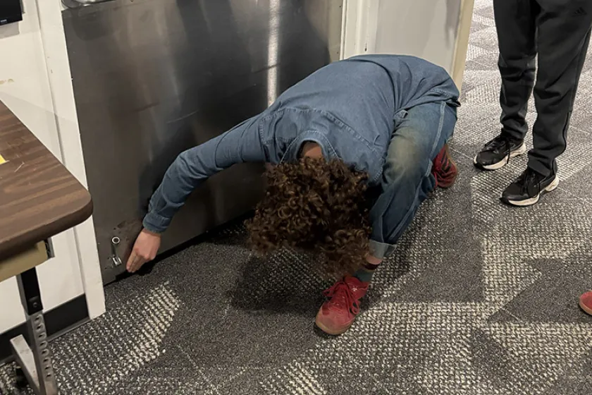 person checking under door