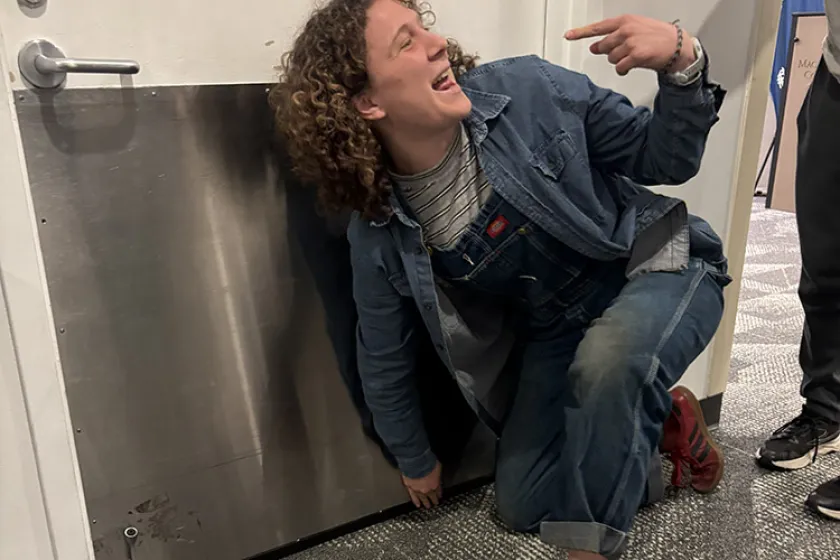 person pointing to door