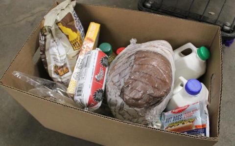 Food box with bread, milk, and other items