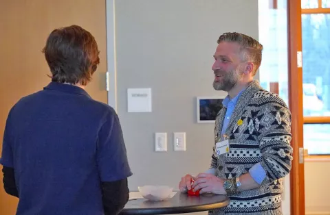 David Schroeder speaking with an attendee