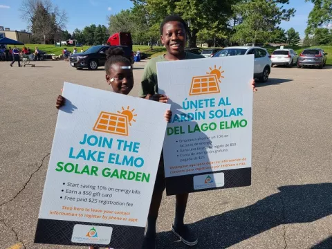 Children holding community solar signs