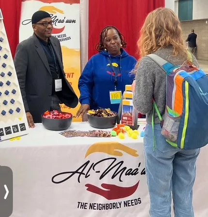 Al-Maa’uun’s Tyrus Hayes (left) meetings with community at an event.