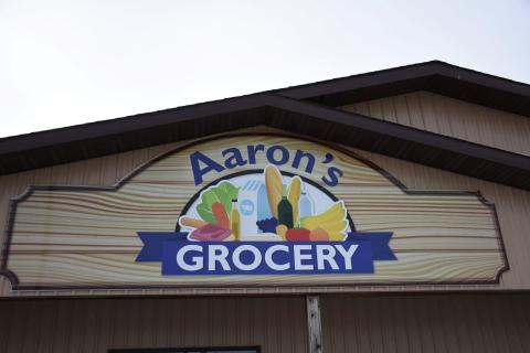 Exterior building sign that says "Aaron's Grocery."