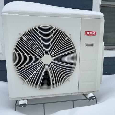 Mini-split outdoor compressor unit in winter at a CERTs staff member's home