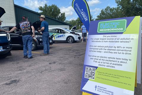 Sign about air pollution from gas-powered vehicles at an EV event