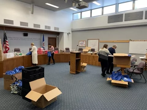 People packing conservation kits