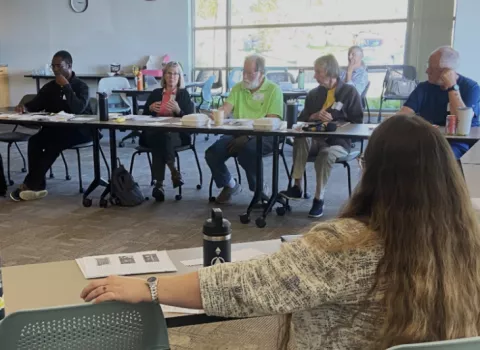 CEA members discussing as a group at a table