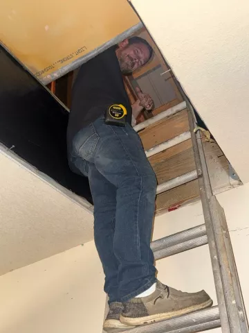 UCAP staff checks out a homeowner’s attic 