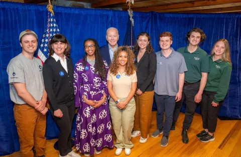 Rau (far right) stands with other AmeriCorps members and former President Biden during a 2024 Earth Day event in Washington D.C.