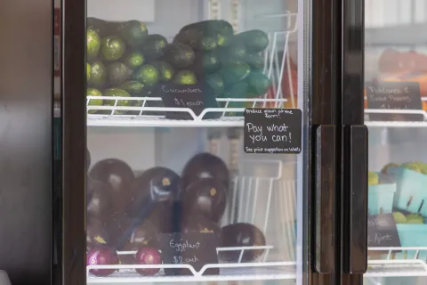 Zucchini and eggplant with price tags in a refrigerator