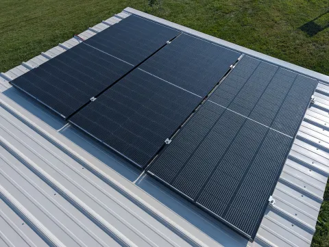 Solar panels on top of the farm stand roof.