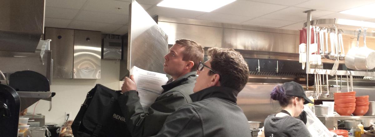 Mike Benike and Dru Larson check out the electrical panel in the Cameo Restaurant kitchen