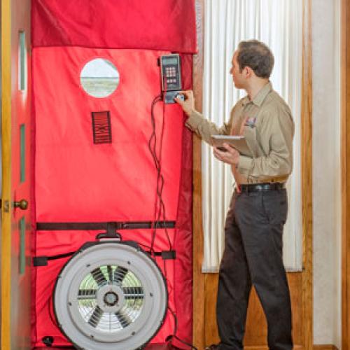 Blower door test to find leaks during energy audit. Photo courtesy Home Energy Squad