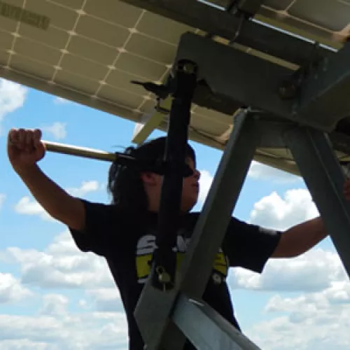 The Popp family children are learning first-hand how solar photovoltaic panels and their wind turbine create energy on their farm