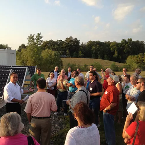 Steve Nisbet from Wright-Hennepin explains to attendees how the solar panel and battery storage systems work.